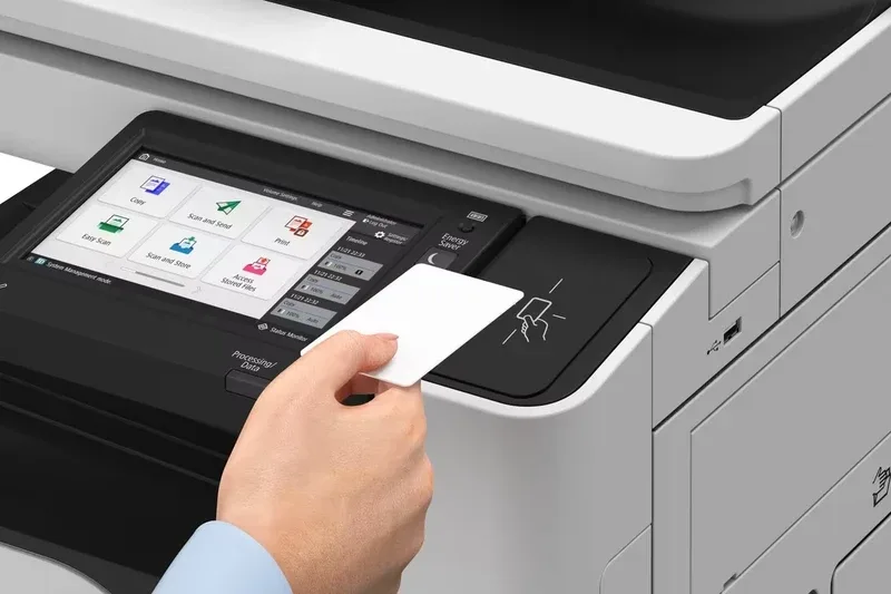 Person tapping an ID card on the Canon imageFORCE 4025/4030 touch control panel
